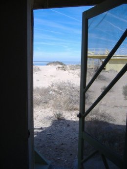 walking out the side door of the cabin.